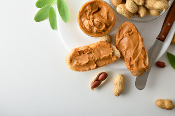 Bread with peanut butter isolated on white table