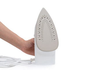 hand holding purple electric iron placed on isolated white background