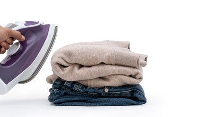 purple electric iron placed and filter the folded cloth on isolated white background