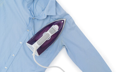 Top view of a purple electric iron placed on a light blue shirt while ironing