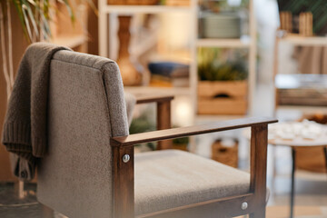 Empty armchair standing in nursing home interior with soft focus on background, suggesting waiting...