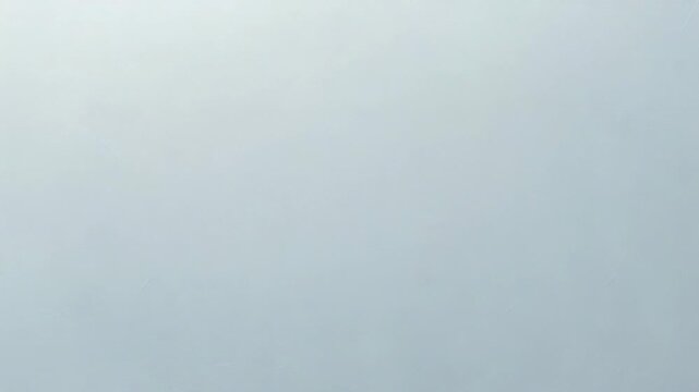 Video A single sheet of paper with creases and folds, lying flat on a white background