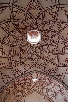 View of geometric patterns dance across the vaulted ceiling, leading the eye to a central skylight in Shahi Hammam, Lahore, Lahore, Pakistan.