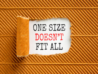 Fototapeta premium One size does not fit all symbol. Concept words One size does not fit all on beautiful white paper. Beautiful brown paper background. Business one size does not fit all concept. Copy space.