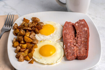 fried eggs  with smoked sausage  and  home fries