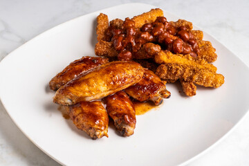 chicken wings   with chicken fries top with chili