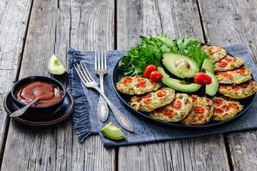 minced chicken cherry tomatoes patties on a plate