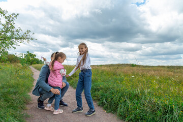 Fototapeta premium Father and children have fun, laugh and enjoy nature outdoors.