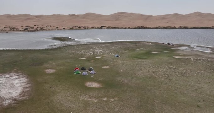 Aerial view of hikers have camp in the oasis in desert
