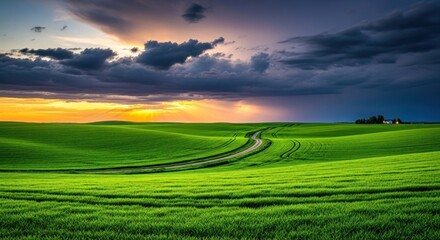 Fototapeta premium Vast Rolling Green Hills Under Dramatic Sunset Sky.