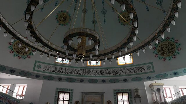 Footage of an elegant chandelier hanging inside a mosque, showcasing Islamic architecture, spiritual atmosphere, and interior design details. Suitable for religious, cultural, and architectural concep