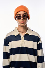 Stylish teenager showcases trendy fashion in stripes and vibrant accessories