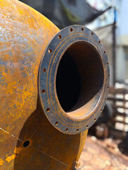 Industrial Flange and Heavy Corrosion on Curved Metal Vessel
