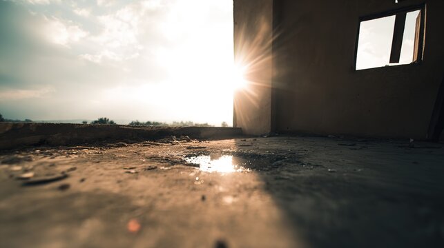 Urban ruin at dusk with soft light through a broken window onto a dusty floor. real-estate listings.