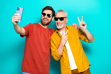 Two men take a selfie together showing friendship and family vibes in casual style