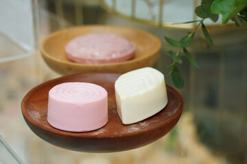 pink soap on wooden plate