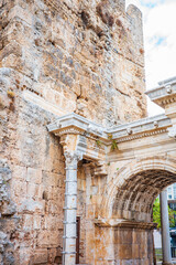 Detailed view of an ancient Roman arch integrated into massive stone city walls in Antalya, Turkey....