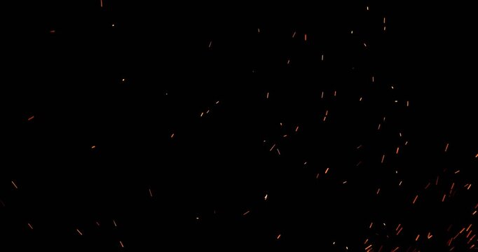 Realistic fire sparks flying through the air in ultra slow motion, isolated on a black background. Perfect as a cinematic VFX overlay, fire particles effect or visual element. Shot in slow motion.