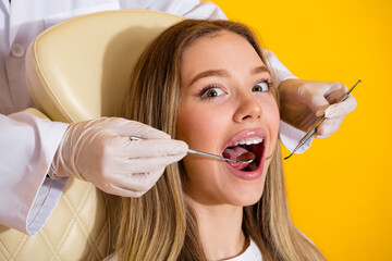Young woman visits the dentist for a checkup in a bright studio style