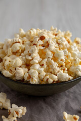 Homemade Salty Popcorn in a Bowl, low angle view. Close-up.