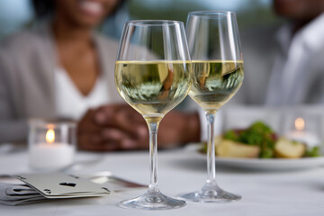 Couple enjoys dinner with wine and cards at a restaurant