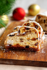 Christmas Stollen Bread made at home with Dried Fruit on a Wooden Board, side view.