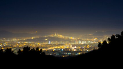 Obraz premium Generative AI depiction of a vibrant cityscape illuminated at night with distant mountains and