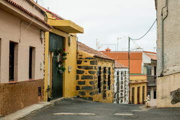 Garachico, Tenerife, Spain - A narrow road winding through colorful buildings, highlighting the unique architectural style of the island
