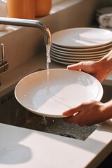 Washing Dishes in Modern Kitchen