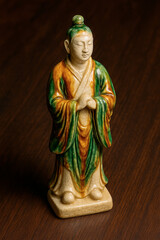Tang Dynasty Sancai Glazed Ceramic Figurine with Polychrome Green and Amber Robes