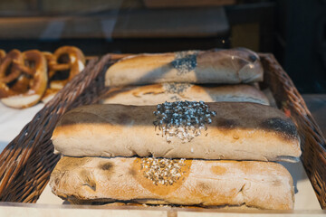 Freshly Baked Loaves of Rustic Bread with Sea Salt Topping Displayed in a Charming Basket at a Vibrant Christmas Market