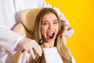 Dental checkup for braces treatment a smiling young woman sits in dental chair while dentist uses...