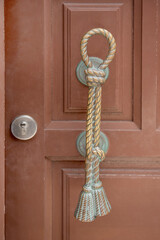 Unique door knocker shaped like a rope, showcasing artistic design and local craftsmanship