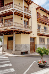 Garachico, Tenerife, Spain: A picturesque corner with elegant balconies and a lush green plant in a pot