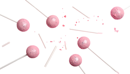 Overhead view of scattered pink lollipops and broken sticks against a black background