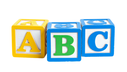 Colorful wooden toy blocks spelling "ABC" against a black backdrop, brightly lit