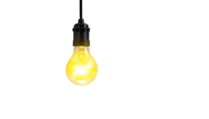 Glowing incandescent lightbulb hanging from a black cord against a deep black background