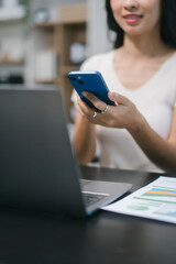 An Asian businesswoman works confidently in a modern office. She represents professionalism, leadership,success, participating in corporate events such as meetings, strategic planning,communications