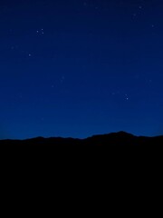 Dark blue night sky with stars over mountain silhouettes, gradient blue, night,  tranquil