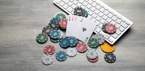 Poker chips and cards with a computer keyboard. Online casino. Gambling