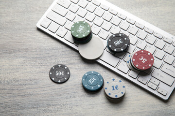 Poker chips on a computer keyboard. Online casino. Gambling