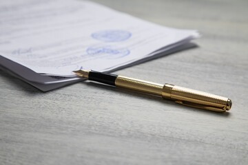 Pen and contract on the table.