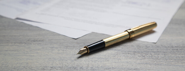 Pen and contract on the table.