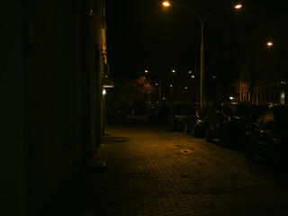 Quiet Residential Street at Night with Warm Street Lights, Parked Cars and Calm Urban Evening Atmosphere