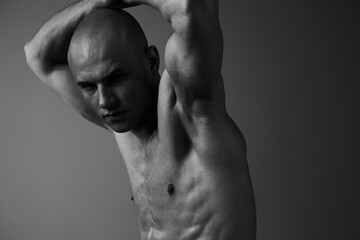 Strong man in black and white, showcasing determination and confidence through a powerful pose and intense expression, highlighting masculinity and strength.