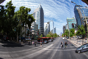 Santiago, Chile - 06 December 2024: View of bustling streets lined with modern buildings under a sky streaked with wispy clouds.