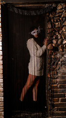 Sexy naked woman behind a curtain of black threads