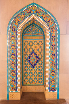 View of intricate arabesque tilework forms an arched alcove, a symphony of turquoise, gold, and cobalt patterns, Sultan Qaboos Street, Muscat, Muscat Governorate, Oman.