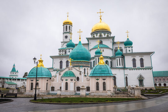 View of the New Jerusalem Monastery gleams with golden domes and turquoise roofs against a somber sky, a testament to architectural grandeur, Istra, Moskovskaya oblast', Russia.