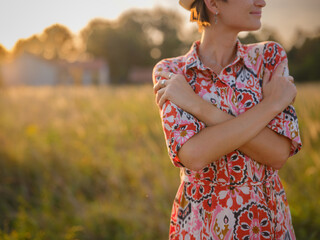 young woman embracing herself, self-love in action, mental health advocate, practicing self-care for finding inner peace, in European countryside